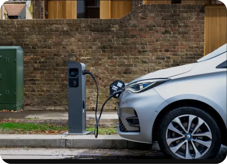 A driver using a mobile app to find and book an EV charging station nearby.