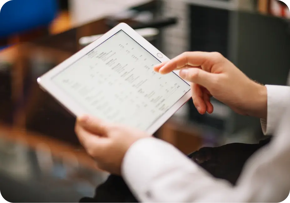 An interface of an automotive dealership management software showing inventory and sales data on a tablet.