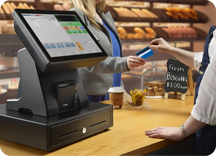 A modern Point of Sale terminal in a retail store processing a transaction.